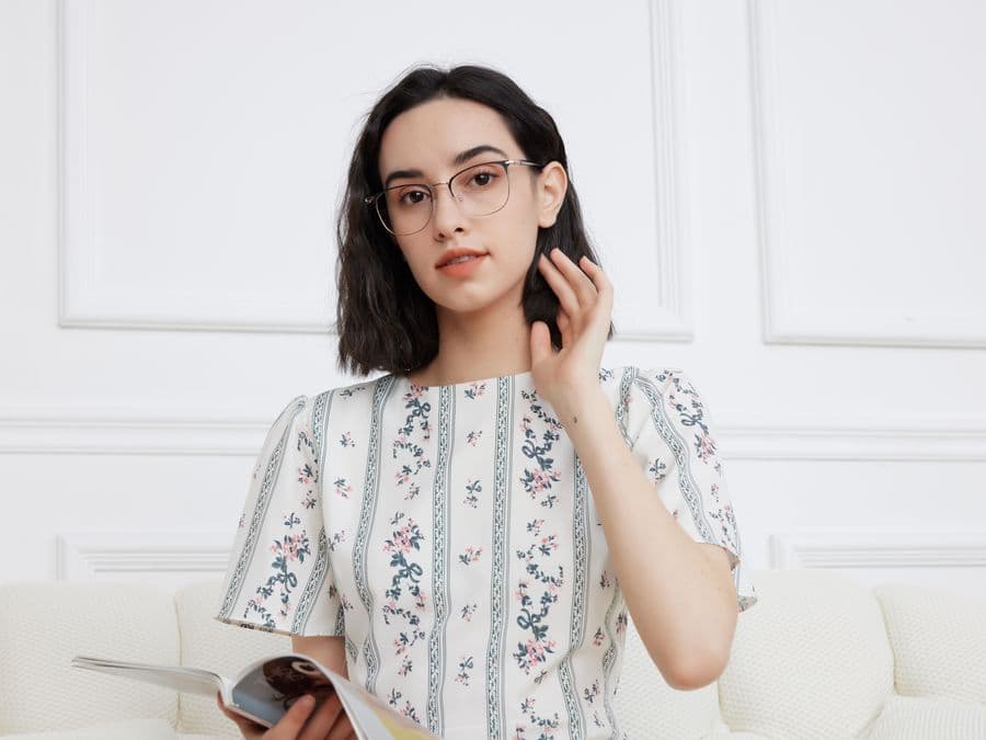 Woman wearing elegant glasses while reading with progressive lenses