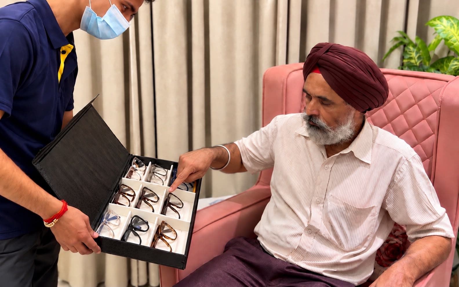 Optometrist fitting a trial frame on a patient during a home frame trial